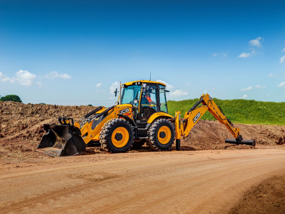 A 5CX Backhoe loader excavating on a dirt path