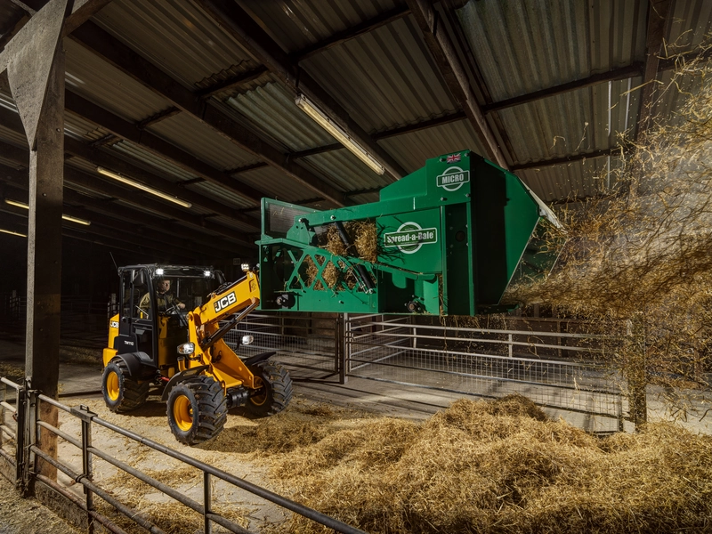 TM110 with spread a bale attachment on 