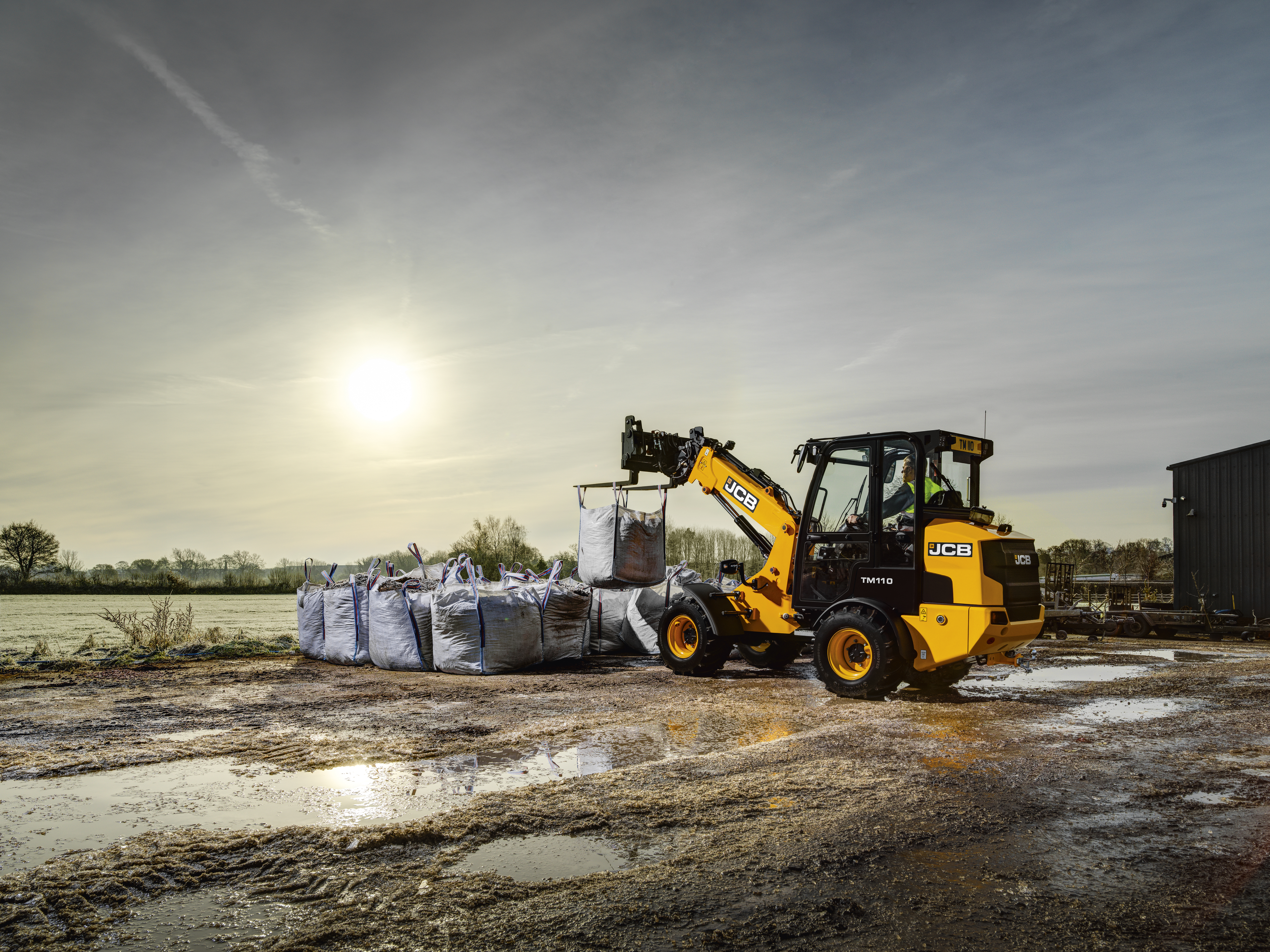 TM110 lifting bags of bark at a builder's merchant