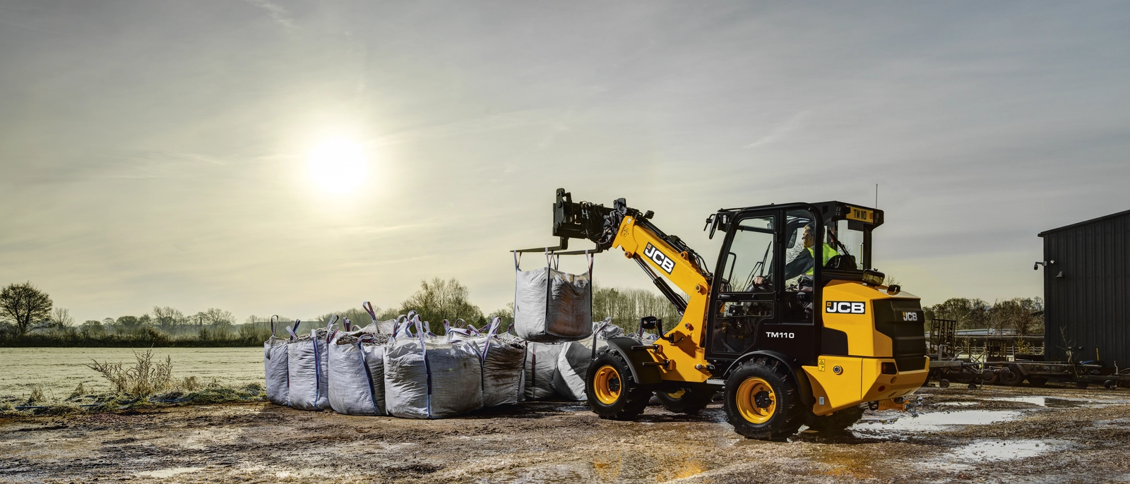 TM110 lifting bags of bark at a builder's merchant