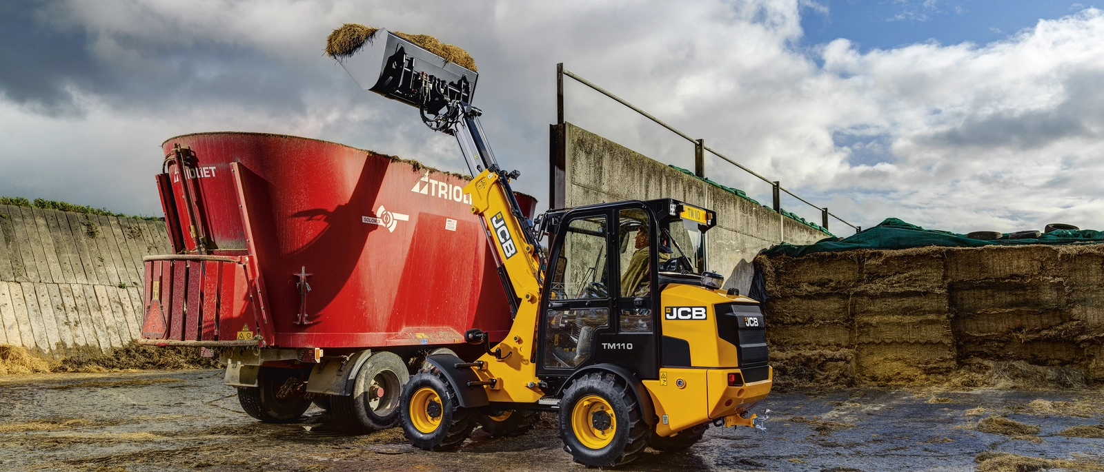 TM110 lifting silage into dispenser