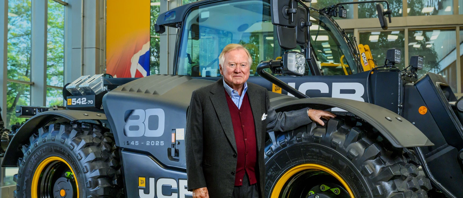 Lord Bamford stood with 80th year Loadall
