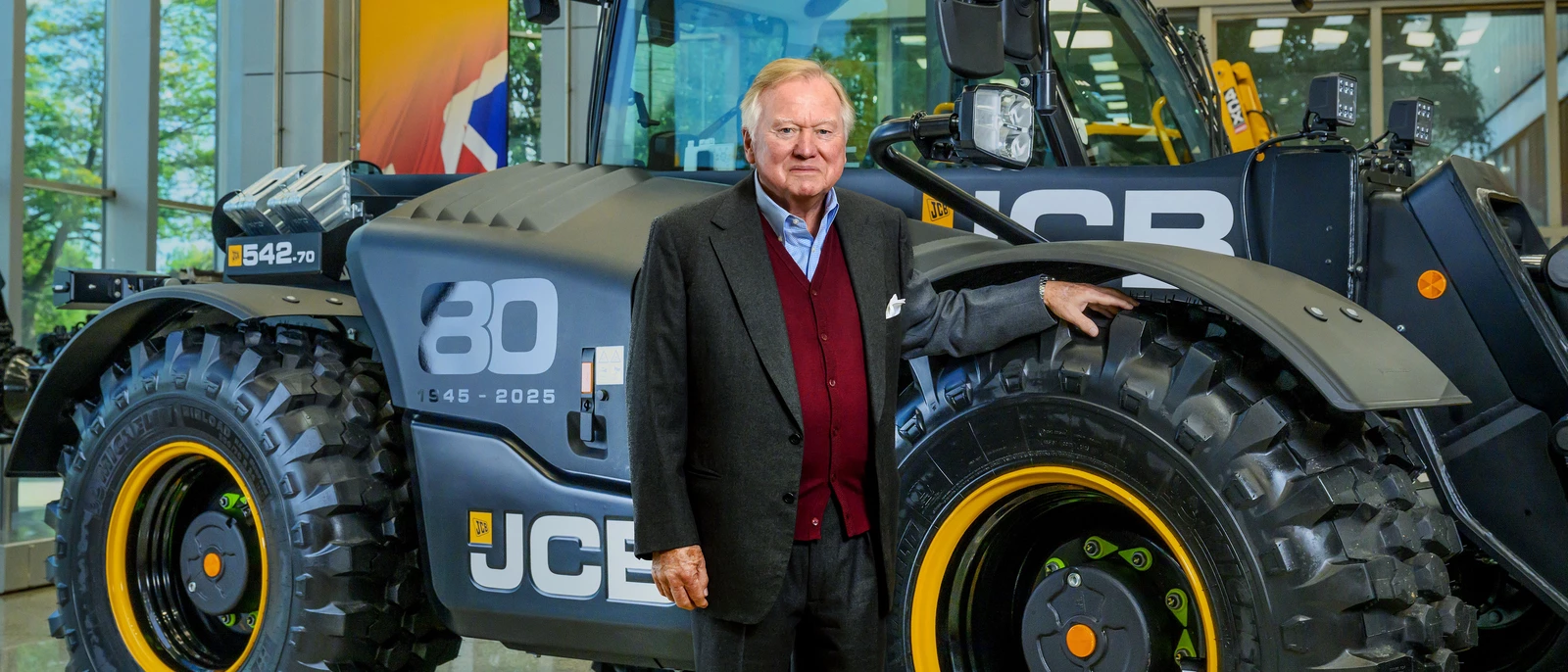 Lord Bamford stood with 80th year Loadall
