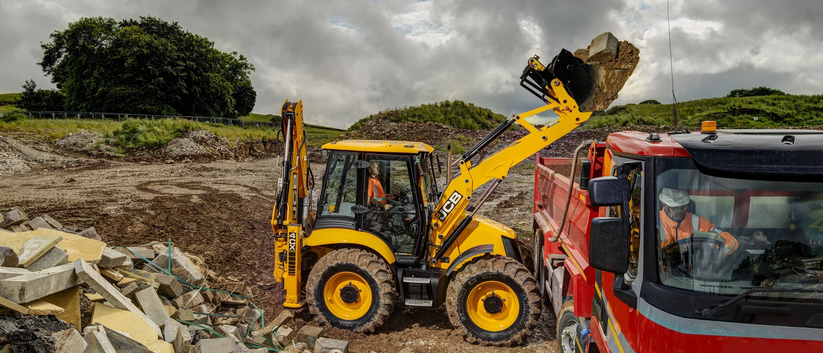 4CX Backhoe Loader, Loading a truck on a construction site.