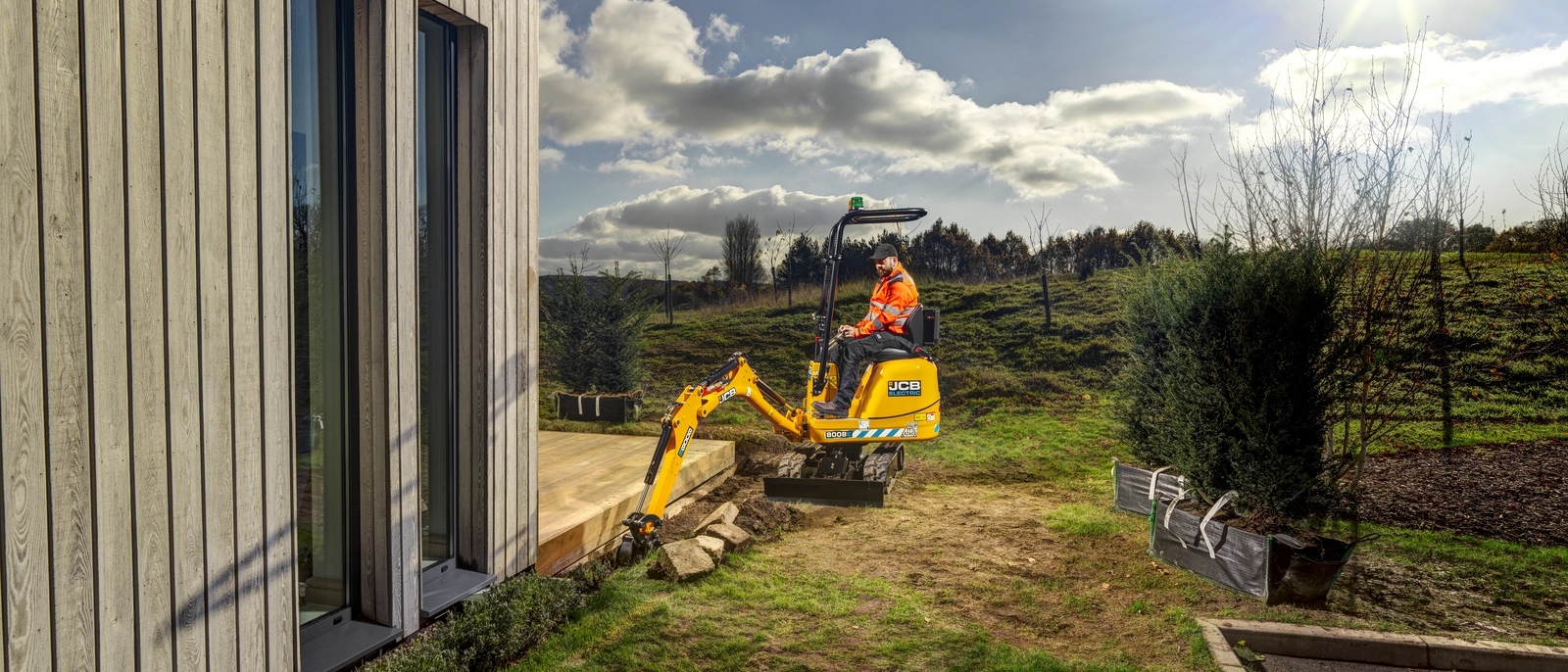 JCB 8008E micro excavator digging a trench for bushes to be planted into. 
