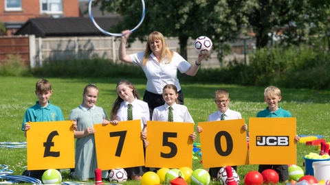Pictured is JCB Marketing Manager Ann Bracken officially handing over the games to children at St Werbergh’s Primary School, Kingsley.
